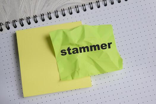 Concept of stammer write on sticky notes isolated on Wooden Table. photo