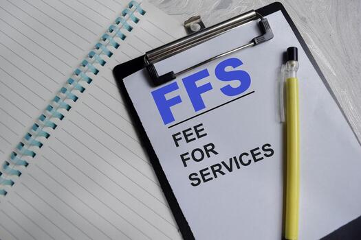 Concept of FFS - fee for services write on clipboard isolated on Wooden Table. photo