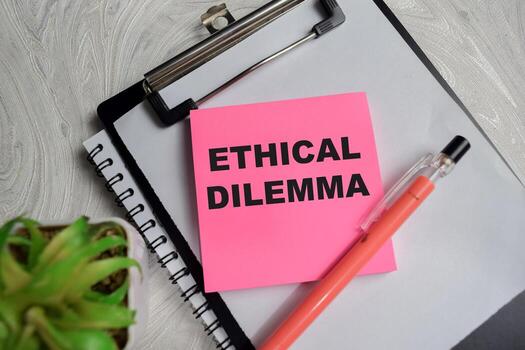 Concept of ethical dilemma write on sticky notes isolated on Wooden Table photo