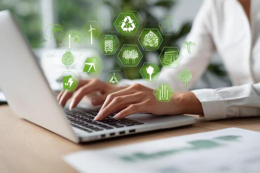 Person using laptop with environmental icons photo