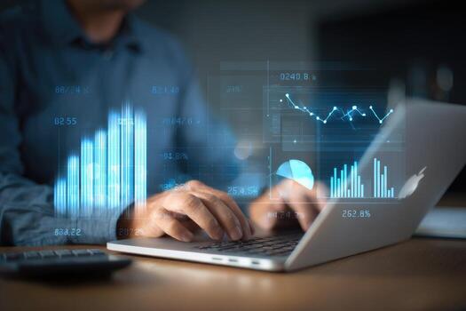 Person using laptop, interactive financial data displayed photo