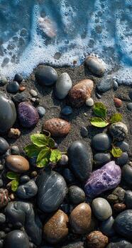 Rocks and pebbles on the beach with water and waves photo