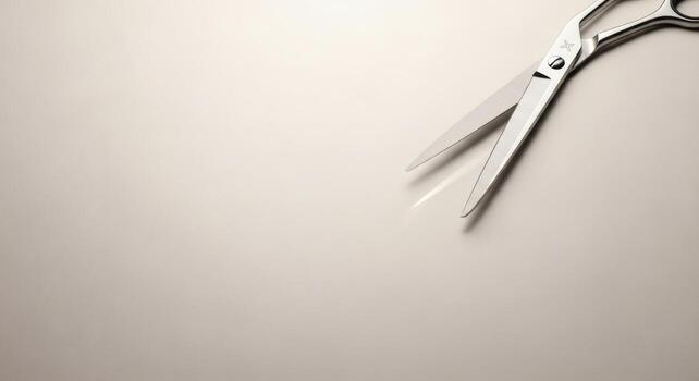 Minimalist silver scissors presented on a clean surface providing ample copy space photo