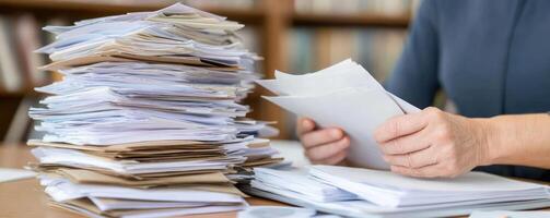 Document review process stack of paperwork in office setting photo