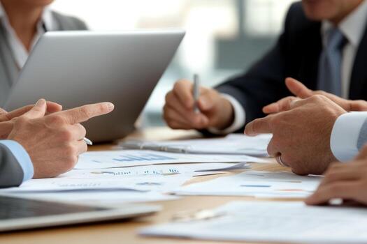Financial data review collaboration in a meeting analyzing charts and graphs on a table photo