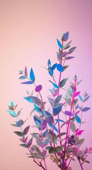 Close up of branches with leaves in vibrant blue pink and purple hues against a soft gradient background photo
