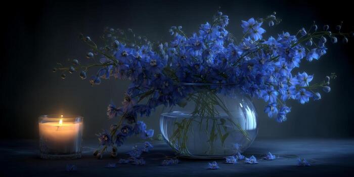 Beautiful blue flowers in a glass vase illuminated by a soft candlelight glow, creating a serene and tranquil atmosphere photo
