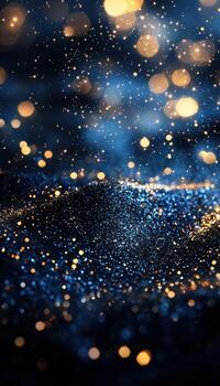 Glittering bokeh lights and sparkling particles in a dark blue background photo