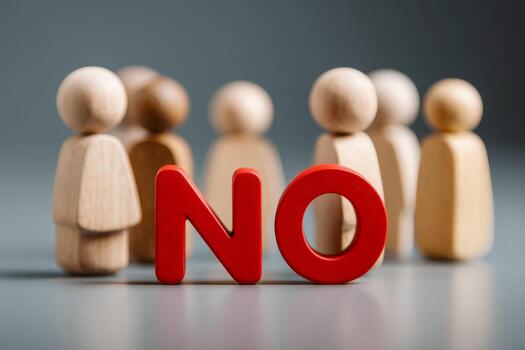 Wooden figurines with a red no sign symbolizing rejection or disapproval photo
