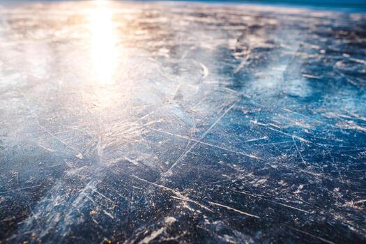 Close-up of an icy surface with visible scratches and frost patterns photo