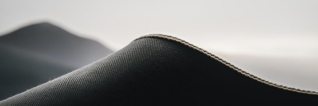 Curved fabric on a landscape backdrop creates a sense of depth and texture in a serene environment photo