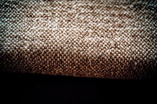 Textured fabric close-up showcasing intricate patterns in warm tones photo