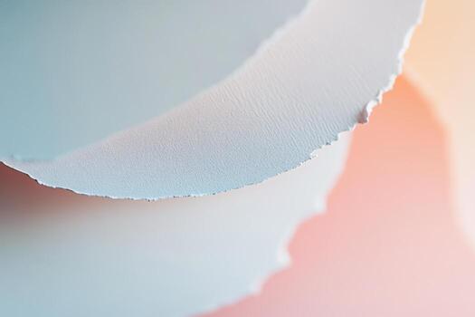Soft textures of torn paper layered together on a pastel background in natural light photo