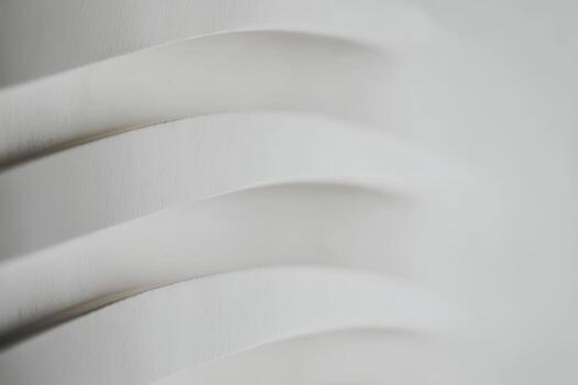 Textured white waves create a sense of depth and movement in minimalist design photo