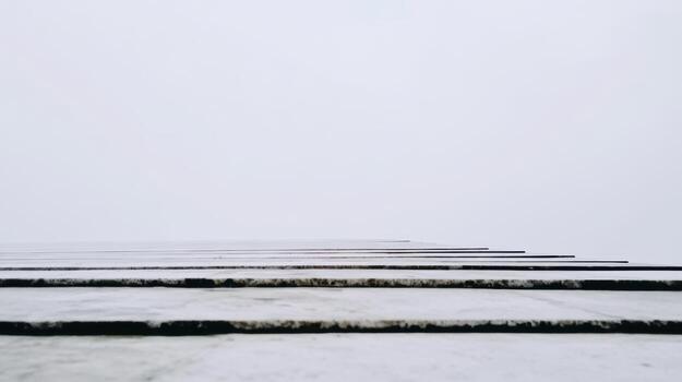 Winter fog envelops a tall building creating a minimalist urban landscape photo