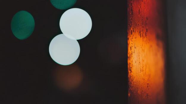 Colorful bokeh lights reflecting on a wet surface during nighttime in an urban setting photo