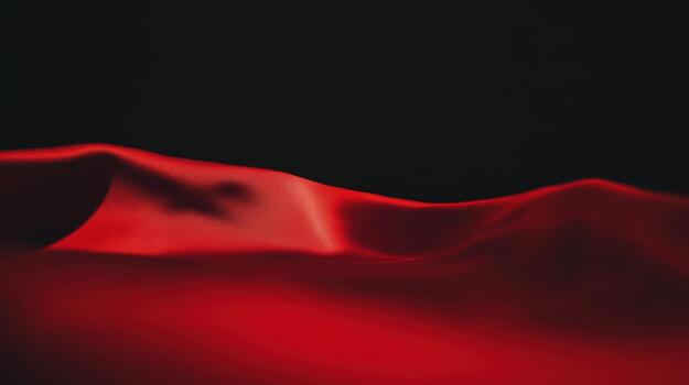 Elegant red fabric flowing in gentle waves against a dark backdrop showcasing texture and movement photo