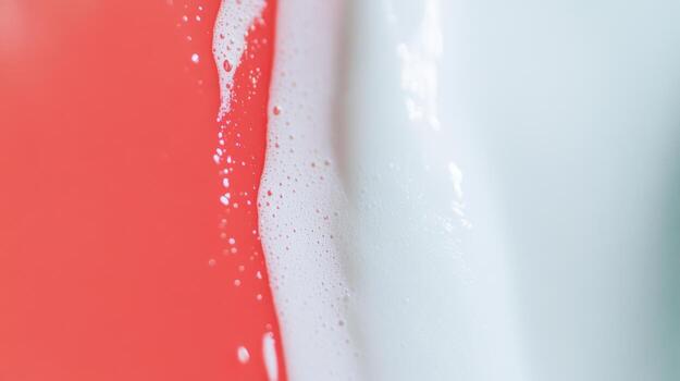 Vibrant red and white paint mixing on a canvas during an art session at a studio photo
