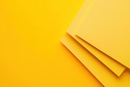 Bright yellow papers stacked at an angle on a solid yellow background for creative projects photo