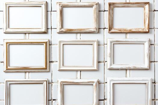 Empty picture frames arranged on a white tiled wall in a creative display photo