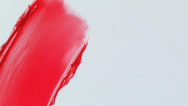 Bright red paint stroke on a white canvas during an art session in a studio photo