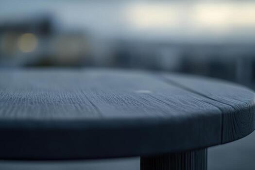 Wooden table surface under soft lighting at an outdoor location during twilight hours photo