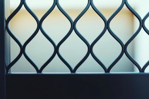 Black decorative metal fence design showing wavy patterns in natural light photo
