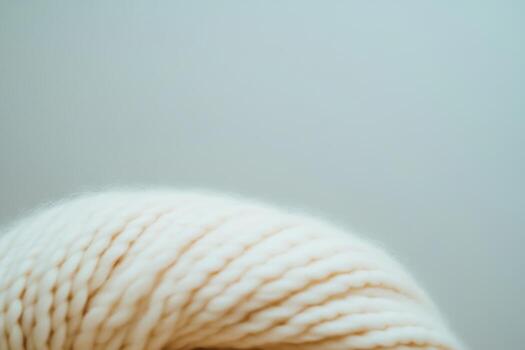 Knitted cream yarn detail showcasing texture and craftsmanship in a simple setting photo