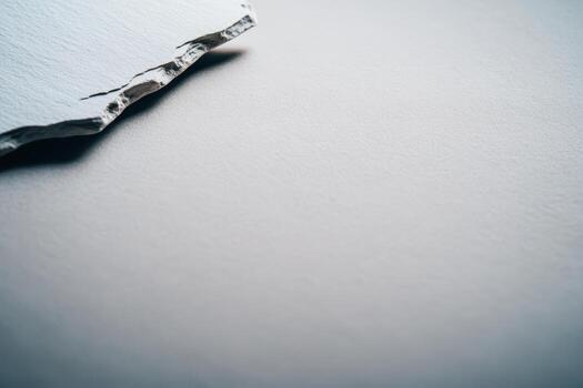 Torn paper edge on a smooth surface creates an interesting textured composition photo