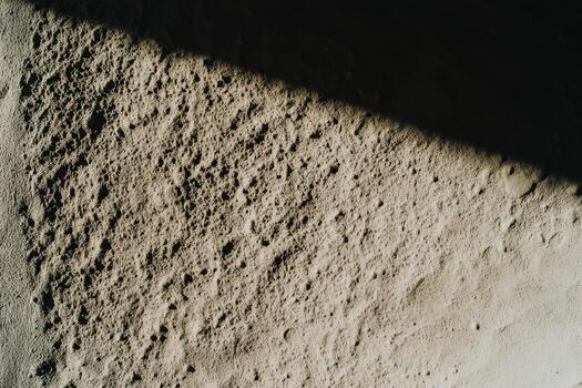 Surface texture with shadows and light during midday in a minimalist setting photo