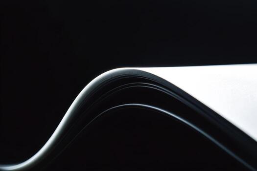 Curved pages of a book lie against a dark background in a soft, artistic composition photo