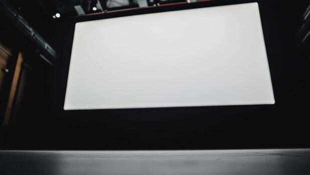 Blank projection screen displayed in an empty theater during an evening event setup photo