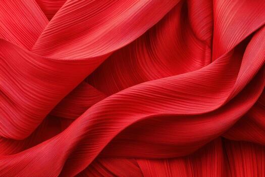 Vibrant red fabric draping elegantly with flowing contours and textures photo