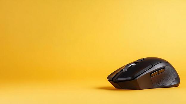 Wireless computer mouse on yellow background for technology and productivity concepts photo