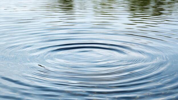 Calm water surface with ripples spreading outward, creating serene atmosphere photo