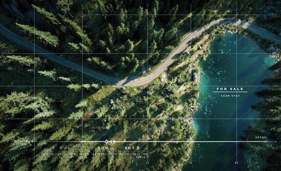 A road winding through the forest with a lake in the middle photo
