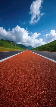 A long empty road with a blue sky and clouds photo