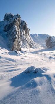 A snowy landscape with rocks and snow photo