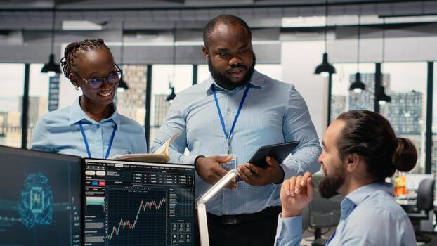Teamworking traders in prop firm office leverage AI tech to interpret charts, optimizing buying and selling. Brokerage coworkers doing brainstorming, using deep learning to maximize profits photo