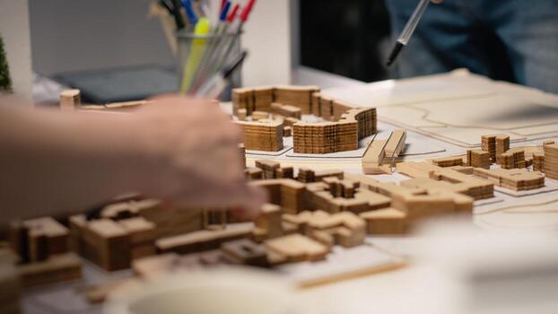 Close up of developers team sharing construction details in a briefing session, analyzing advanced architectural software and 3D models for a modern structural housing project. photo