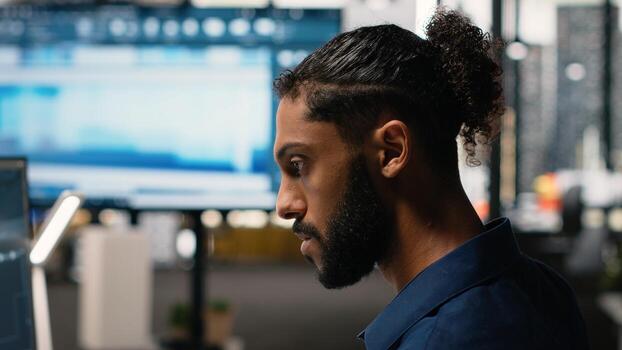 Middle eastern guy uses artificial intelligence neural networks for urban redevelopment project, big data and advanced analytics streamlining architectural design. Sustainable housing. photo