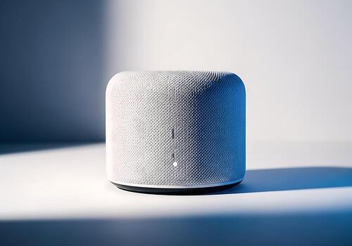 A Modern Smart Speaker Device With A Textured White Fabric Covering And Subtle Light Indicator, Set Against A Clean, Minimalist Background. photo