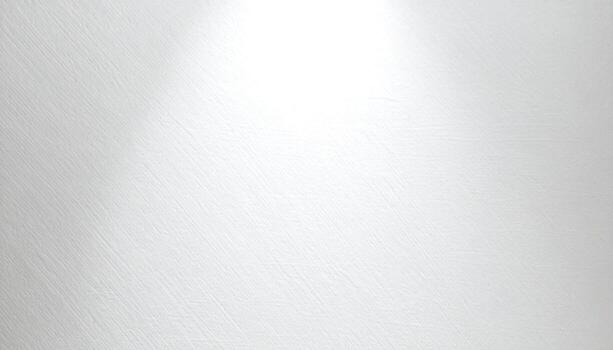 A close-up view of a smooth, textured white surface, illuminated by a directional light source. photo