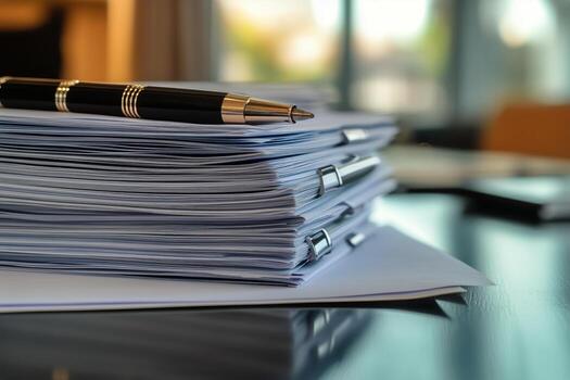 Documents Organized on Table With Pen and Potted Plant in Background During Daylight in Office Setting. photo