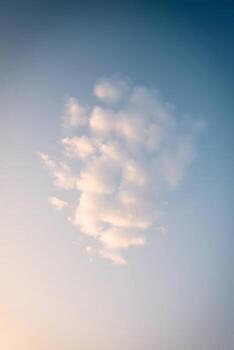 Soft, dreamy clouds floating in a beautiful gradient sky, perfect for background use photo