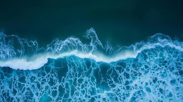 Stunning aerial view captures the dynamic power and mesmerizing beauty of crashing ocean waves with intricate foam patterns. photo