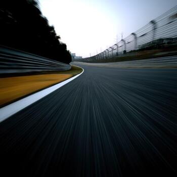 A blurry image of a racing track with a car driving on it photo