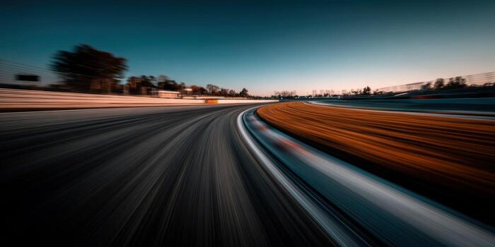 A blurry image of a racing track at sunset photo