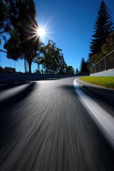 A motion blurred image of a road with a sun in the background photo