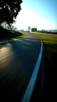 A blurry image of a road with a curve photo
